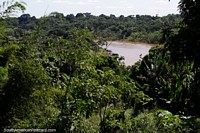 Green jungle surrounds the river and city of Rio Branco in the Amazon Basin. Brazil, South America.