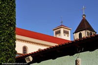 2 of the cathedral towers, the red roof and green hedge in Rio Branco. Brazil, South America.