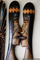 Wooden crafts of indigenous faces at the crafts fair in Porto Velho, face to face.