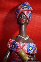 Larger version of Woman wears a matching head-wrap and dress and a silver necklace, crafts in Porto Velho.