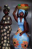 Woman in blue with a fruit platter on her head and a woman in black and white, ceramic figures in Porto Velho. Brazil, South America.