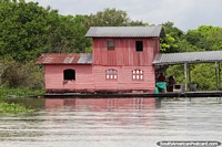 Brazil Photo - 2 storey pink house built on a platform on the Amazon river in Manaus.