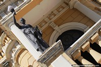 Statue holding a light at the main entrance of Rio Negro Palace in Manaus. Brazil, South America.