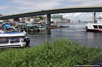 Bridge over the Negro River in Manaus, boats and buildings.