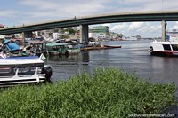 Bridge over the Negro River in Manaus, boats and buildings. Brazil, South America.