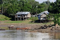 Boats moored in front of houses on the Amazon River. Brazil, South America.