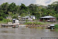 Small village with workers waiting on the riverside in the Amazon.