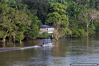 Riverboat speeds up the great waters of the Amazon. Brazil, South America.