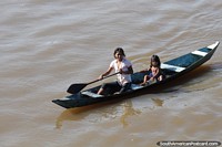 2 indigenous girls of the Amazon in a canoe on the river around Tefe. Brazil, South America.