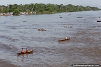 Brazil Photo - Children of an Amazon village wait in canoes for presents thrown by passengers of a ferry passing by.