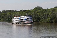 A.Nunes II, small hammock ferry cruising along the Amazon River. Brazil, South America.