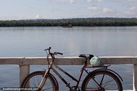 Xingu River in the morning in Altamira, a bicycle leans against the barrier.