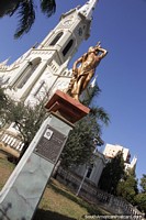 San Sebastian, gold statue with the Metropolitan Cathedral behind in Uberaba.