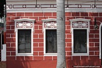 Well-kept antique facade of a bar in Corumba with decorated windows. Brazil, South America.