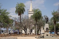 Larger version of Independence Park with church, monument and palm trees in Corumba.
