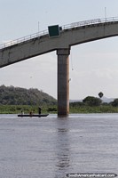 Boat under the bridge in the port area in Corumba. Brazil, South America.