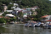 Houses perched on the hillside overlooking the Barra Canal in Barra da Lagoa, Florianopolis. Brazil, South America.