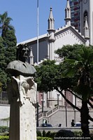 Monument of Dante Alighieri with an eagle and the cathedral in Caxias do Sul.