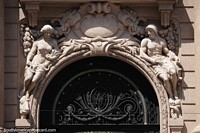 Ceramic figures above an arched building entrance in Porto Alegre. Brazil, South America.