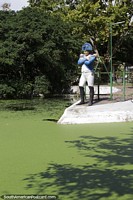 Military General, statue beside the green waters at Plaza Tamandare in Rio Grande. Brazil, South America.