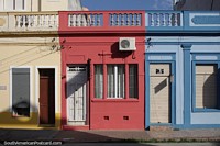 3 small colored houses in a row - yellow, red and blue, Pelotas.