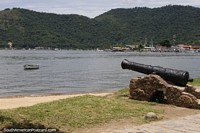 Black cannon on a stone base pointing out to sea in Paraty.