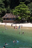 People enjoy the beaches of the islands in the bay in Paraty.