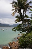 Picturesque bay with rocks, palms and turquoise waters on Ilha Grande.