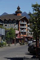 Chile Photo - Wooden building with a tower, shops and apartments in Pucon.