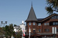 Chile Photo - Prominent brown wooden building with tower on the main road area beside the lake in Puerto Varas.