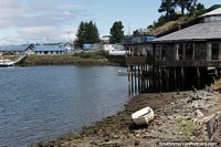 Chile Photo - The coastline in Castro with beach and building on stilts.
