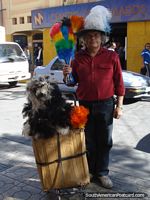 The Dust Brush Man with his colorful brushes on his head poses for a photo in Calama. Chile, South America.