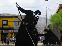 Chile Photo - A black art piece of a man and children at Paseo Arturo Prat in Antofagasta.