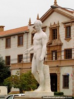 Male white statue artwork and an historical building in La Serena. Chile, South America.