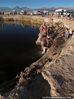 Other people climb down to the waters edge for a swim at San Pedro de Atacama. Chile, South America.