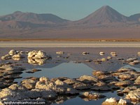 Chile Photo - Crusty salt islands and distant mountains, a lagoon between at San Pedro de Atacama.