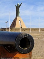 Cannon and Jesus statue at the top of the headland in Arica. Chile, South America.