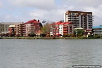 Apartments along the riverfront make a colorful and pretty picture in Valdivia. Chile, South America.