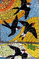 Birds ascending to the sky, tiled pictures at the plaza in Puerto Montt. Chile, South America.