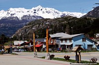 Houses and shops in Futaleufu, a huge snow-capped mountain towers above! Chile, South America.