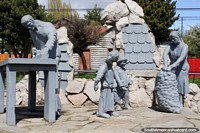 Los Chilotes monument to the immigrants, a family working, bagging produce and woodwork, Coyhaique. Chile, South America.