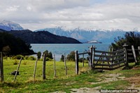 Great view of Lake General Carrera with a wooden fence and gate on grassland at Puerto Rio Tranquilo.
