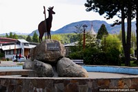 Symbols of the Huemul deer upon rocks in the fountain at the plaza in Cochrane. Chile, South America.