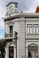 European architecture in Punta Arenas, building with a clock-face, a shop below. Chile, South America.