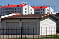 Bright red roofs on tall white buildings, very eye-catching sight in Punta Arenas. Chile, South America.
