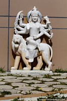 Female Hindu God with 8 arms rides a lion, marble sculpture at the temple in Punta Arenas. Chile, South America.