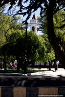 View to the cathedral through Plaza Munoz Gamero, nice and green in Punta Arenas. Chile, South America.