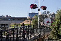 Iron bridge with flower pots above and the city behind in Vina del Mar. Chile, South America.