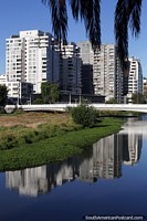 Modern buildings reflecting in the estuary in the morning in Vina del Mar. Chile, South America.