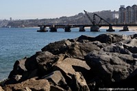 Wharf and beach with rocks in the foreground in beautiful Vina del Mar. Chile, South America.